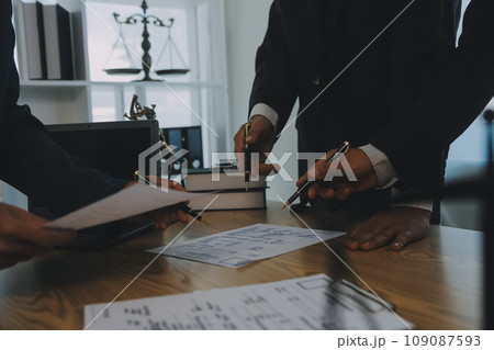 Consultation and conference of Male lawyers and professional businesswoman working and discussion having at law firm in office. Concepts of law, Judge gavel with scales of justice. Consultation and conference of Male lawyers and professional businesswoman working and discussion having at law firm in office. Concepts of law, Judge gavel with scales of justice. 109087593