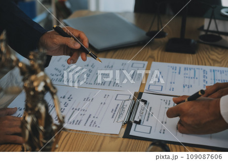 Consultation and conference of Male lawyers and professional businesswoman working and discussion having at law firm in office. Concepts of law, Judge gavel with scales of justice. Consultation and conference of Male lawyers and professional businesswoman working and discussion having at law firm in office. Concepts of law, Judge gavel with scales of justice. 109087606