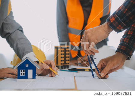 Construction and structure concept of Engineer or architect meeting for project working with partner and engineering tools on model building and blueprint in working site, contract for both companies. Construction and structure concept of Engineer or architect meeting for project working with partner and engineering tools on model building and blueprint in working site, contract for both companies. 109087621