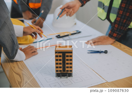 Construction and structure concept of Engineer or architect meeting for project working with partner and engineering tools on model building and blueprint in working site, contract for both companies. 109087630