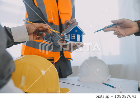 Construction and structure concept of Engineer or architect meeting for project working with partner and engineering tools on model building and blueprint in working site, contract for both companies. Construction and structure concept of Engineer or architect meeting for project working with partner and engineering tools on model building and blueprint in working site, contract for both companies. 109087643