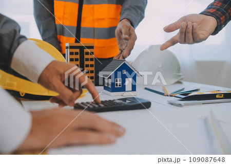 Construction and structure concept of Engineer or architect meeting for project working with partner and engineering tools on model building and blueprint in working site, contract for both companies. 109087648