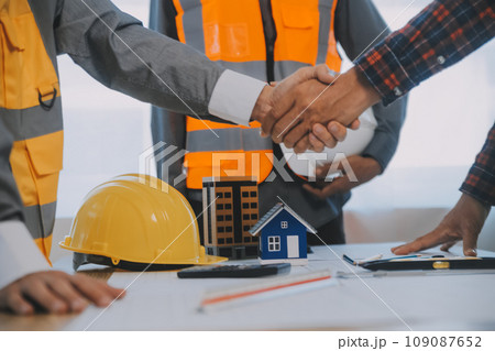 Construction and structure concept of Engineer or architect meeting for project working with partner and engineering tools on model building and blueprint in working site, contract for both companies. Construction and structure concept of Engineer or architect meeting for project working with partner and engineering tools on model building and blueprint in working site, contract for both companies. 109087652