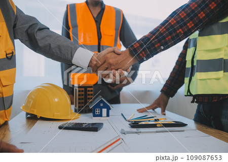 Construction and structure concept of Engineer or architect meeting for project working with partner and engineering tools on model building and blueprint in working site, contract for both companies. Construction and structure concept of Engineer or architect meeting for project working with partner and engineering tools on model building and blueprint in working site, contract for both companies. 109087653