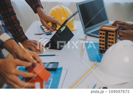 Construction and structure concept of Engineer or architect meeting for project working with partner and engineering tools on model building and blueprint in working site, contract for both companies. Construction and structure concept of Engineer or architect meeting for project working with partner and engineering tools on model building and blueprint in working site, contract for both companies. 109087672