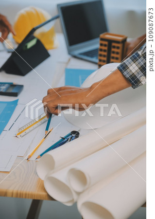 Construction and structure concept of Engineer or architect meeting for project working with partner and engineering tools on model building and blueprint in working site, contract for both companies. Construction and structure concept of Engineer or architect meeting for project working with partner and engineering tools on model building and blueprint in working site, contract for both companies. 109087673