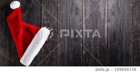 Santa Claus hat on wooden rustic background. Christmas and new year celebration 109088136