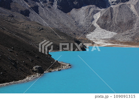Bright turquoise water of Lake Gokyo, Nepal. Bright turquoise water of Lake Gokyo, Nepal. 109091315