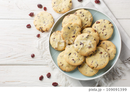 buttery cranberry orange shortbread cookies closeup on the plate. Horizontal top view buttery cranberry orange shortbread cookies closeup on the plate. Horizontal top view 109091399
