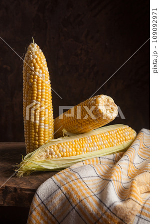 Several cobs sweet corn on wooden background.. Several cobs sweet corn on wooden background.. 109092971