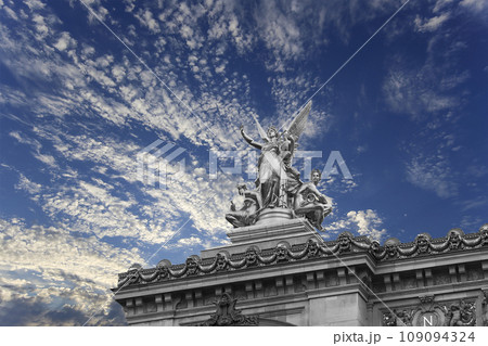Golden statue of Liberty on the roof of the Opera Garnier (Garnier Palace) against the sky with clouds. Sculpted by Charles Gumery in 1869. Paris, France. UNESCO World Heritage Site Golden statue of Liberty on the roof of the Opera Garnier (Garnier Palace) against the sky with clouds. Sculpted by Charles Gumery in 1869. Paris, France. UNESCO World Heritage Site 109094324