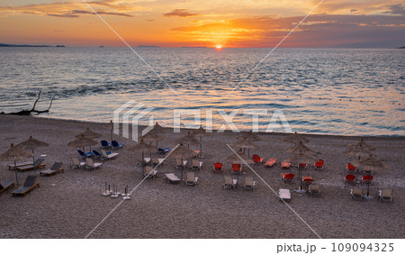 Sarande beach during sunset. Bistrica Beach with view at Sarande city. beautiful evening sky Sarande beach during sunset. Bistrica Beach with view at Sarande city. beautiful evening sky 109094325