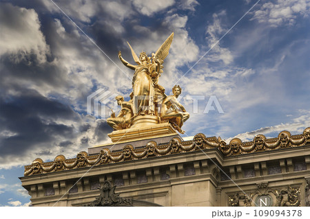 Golden statue of Liberty on the roof of the Opera Garnier (Garnier Palace) against the sky at sunset. Sculpted by Charles Gumery in 1869. Paris, France. UNESCO World Heritage Site Golden statue of Liberty on the roof of the Opera Garnier (Garnier Palace) against the sky at sunset. Sculpted by Charles Gumery in 1869. Paris, France. UNESCO World Heritage Site 109094378