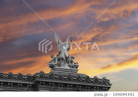 Golden statue of Liberty on the roof of the Opera Garnier (Garnier Palace)  against the sky at sunset. Sculpted by Charles Gumery in 1869. Paris, France. UNESCO World Heritage Site 109094391
