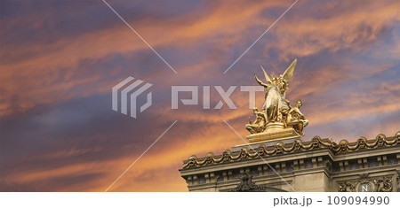 Golden statue of Liberty on the roof of the Opera Garnier (Garnier Palace)  against the sky at sunset. Sculpted by Charles Gumery in 1869. Paris, France. UNESCO World Heritage Site 109094990