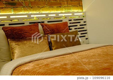 Interior photography, modern bedroom, with large stylish bed, modern design, in beige Interior photography, modern bedroom, with large stylish bed, modern design, in beige 109096110