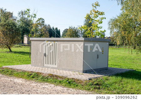 Electric power transformer. Outdoor space, park and green area 109096262