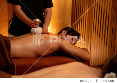 Hot herbal ball spa massage body treatment with couple customer. Quiescent 109097366