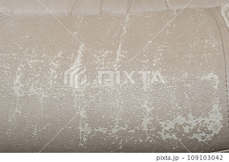 Defects on a white leather sofa. Damaged to leather furniture. 109103042