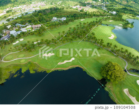 Aerial view of beautiful green golf field fairway and putting green,Top view image for sport background and travel nature background, Amazing green nature view 109104508