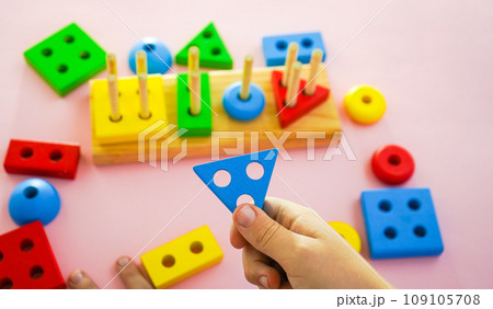 eco wooden toys. The child collects a sorter. Educational logic toys for kids. Games for Child Development eco wooden toys. The child collects a sorter. Educational logic toys for kids. Games for Child Development 109105708