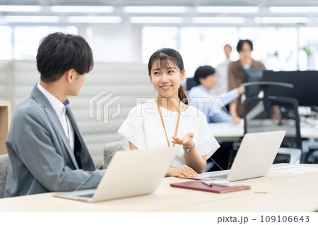 オフィスで打ち合わせをする若い男女のエンジニア オフィスで打ち合わせをする若い男女のエンジニア 109106643
