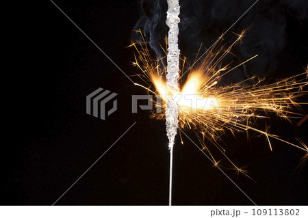 sparkler with sparks on a black background sparkler with sparks on a black background 109113802
