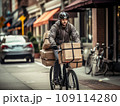 Focused young male delivery man in protective helmet riding bicycle with cardboard boxes on street in city 109114280