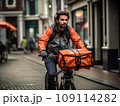 Focused young male delivery man in protective helmet riding bicycle with cardboard boxes on street in city 109114282