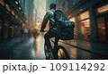 Focused young male delivery man in protective helmet riding bicycle with cardboard boxes on street in city 109114292