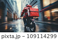 Back view of anonymous delivery moto scooter driver riding motorcycle with red backpack on city street 109114299