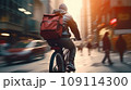 Focused young male delivery man in protective helmet riding bicycle with cardboard boxes on street in city 109114300