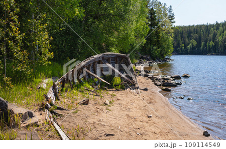 The remains of an old wooden boat on the shore of Valaam Island The remains of an old wooden boat on the shore of Valaam Island 109114549