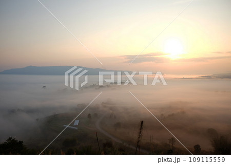 Beautiful Sunset and sunrise on sky and golden twilight time with mist and fog in valley of layer mountain 109115559