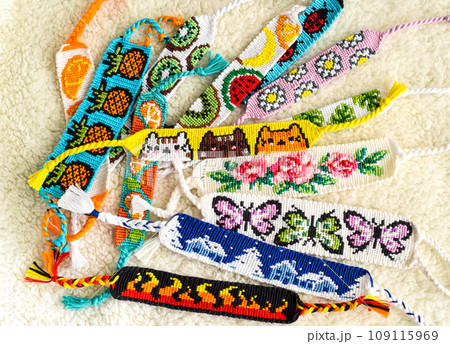 DIY woven friendship bracelets with different braiding. Summer accessory 109115969