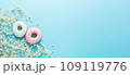 Delicious donuts and delicate white bouquet of flowers on light blue background. Top view, banner 109119776