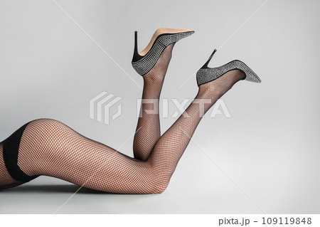 Woman wearing black tights and stylish shoes on light grey background, closeup of legs 109119848