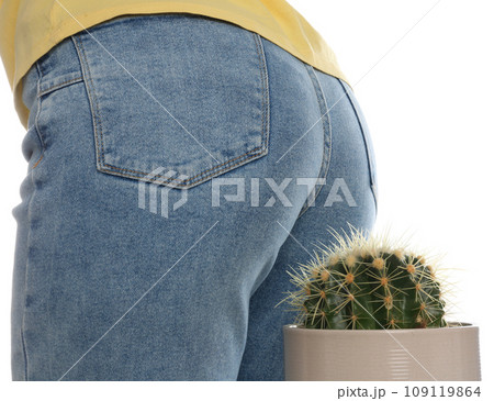 Woman sitting down on cactus against white background, closeup. Hemorrhoid concept 109119864