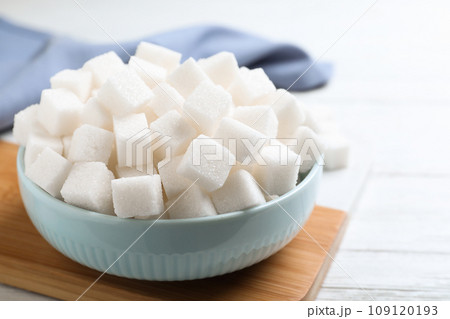 Refined sugar cubes on white wooden table Refined sugar cubes on white wooden table 109120193