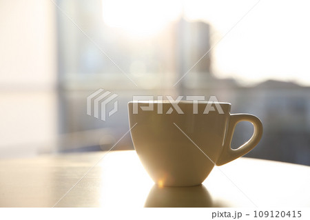 Cup of hot drink on table in morning. Space for text 109120415