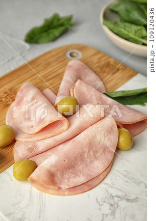 Ham with olives and spinach on table Ham with olives and spinach on table 109120436