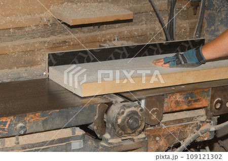 Male Production Workshop Worker Hand Grinding Wooden Board On Machine Tool Industrial Equipment 109121302