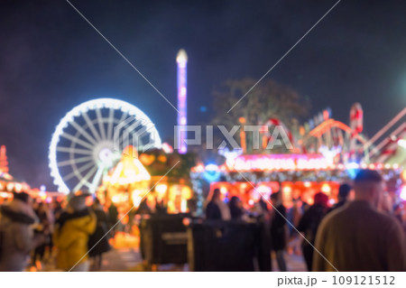 Blurred image bokeh of People walking, shopping at Winter Wonderland, a Christmas Market in Hyde Park, London. 109121512