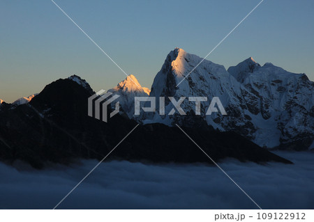 Sun lit mountains Ama Dablam and Cholatse at sunset, Nepal. 109122912