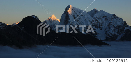 Sun lit peak of Mount Ama Dablam and Cholatse at sunset, Nepal. 109122913