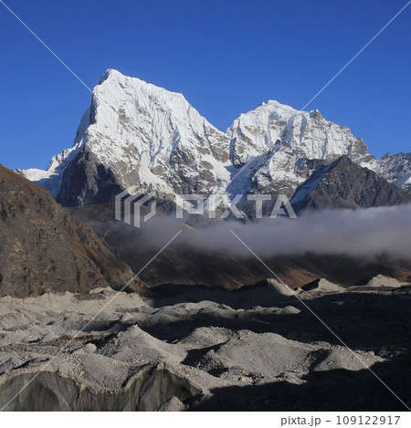 Ngozumba Glacier and snow covered mountains Cholatse and Tobuche, Nepal. 109122917