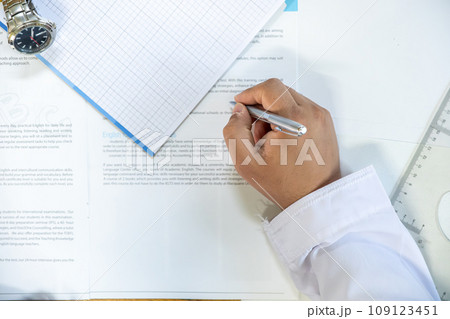Arabic man holding pen while reading the contract before signing it 109123451