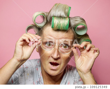 surprised senior women with hair rolls and glasses 109125349