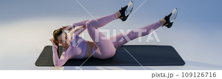 Athletic woman shaking press on studio background. Fitness, healthy lifestyle and sport concept Athletic woman shaking press on studio background. Fitness, healthy lifestyle and sport concept 109126716