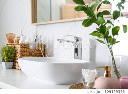 Modern vessel sink with faucet in stylish bathroom Modern vessel sink with faucet in stylish bathroom 109129326